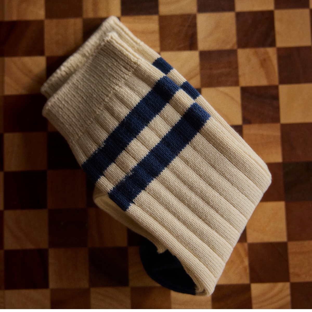 MILWORKS Racquet Club Collection ribbed cotton athletic socks in cream with navy blue stripes on a checkered board
