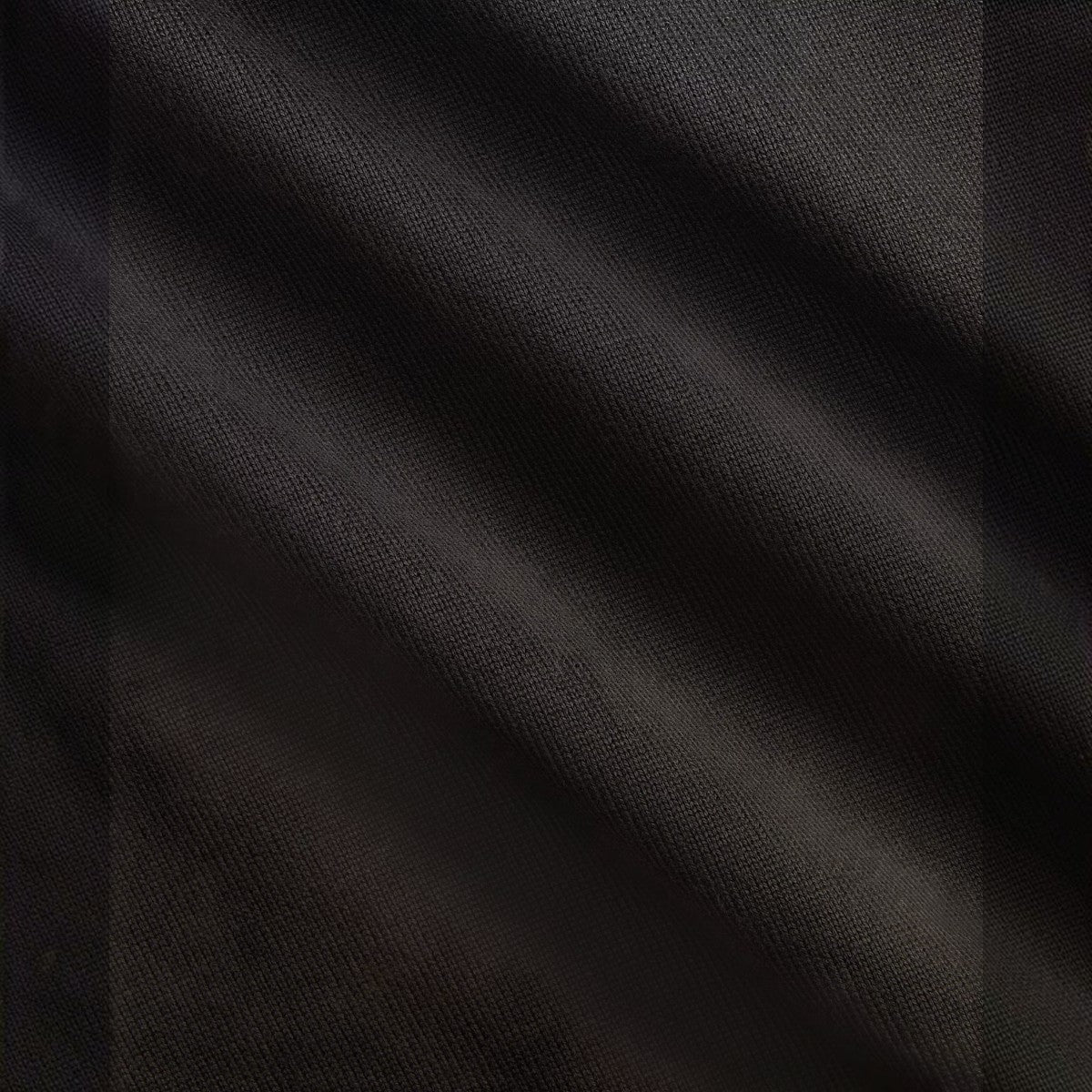 RRL faded black cotton jersey fabric with a soft, lived-in texture and visible weave detail.