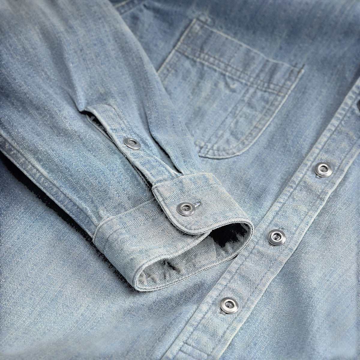 RRL indigo denim workshirt in Manvil wash with herringbone pattern, distressed metal buttons, and barrel cuffs.