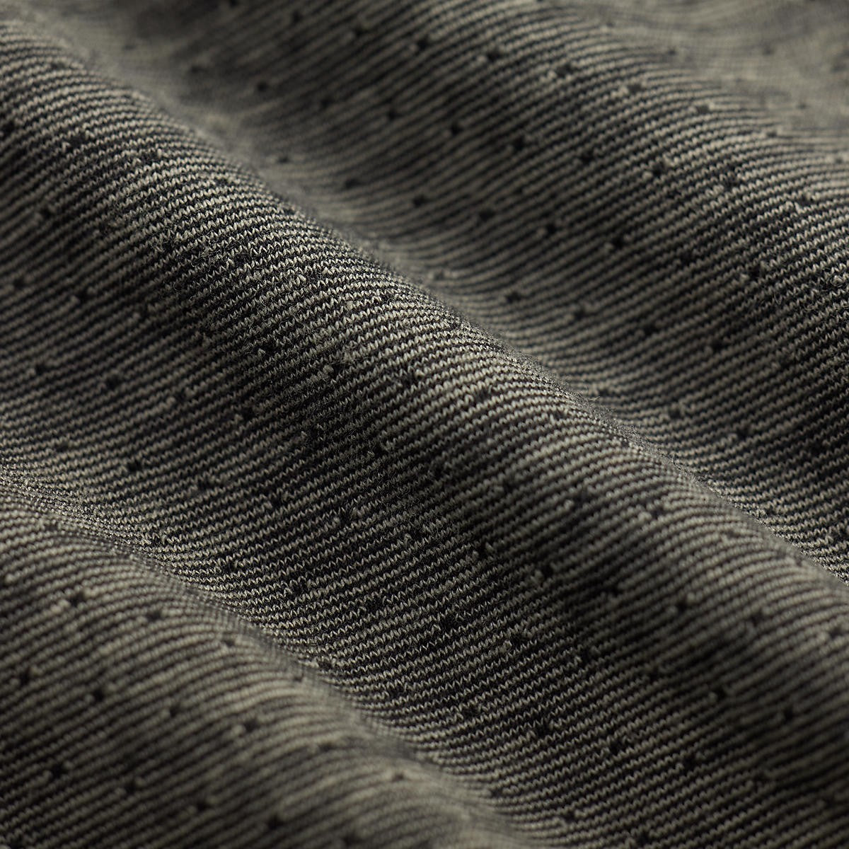 Close-up of RRL indigo jacquard cotton fabric with a textured black and multi-tone striped pattern.