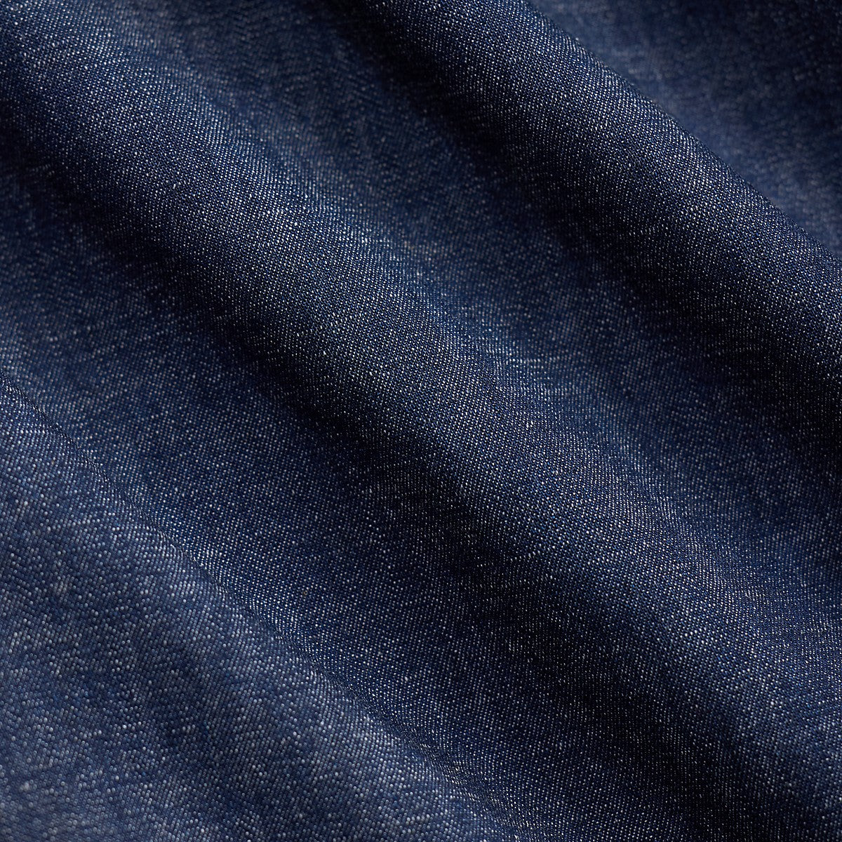 Close-up of RRL indigo rinse denim fabric showing the subtle nep texture and deep blue cotton weave.