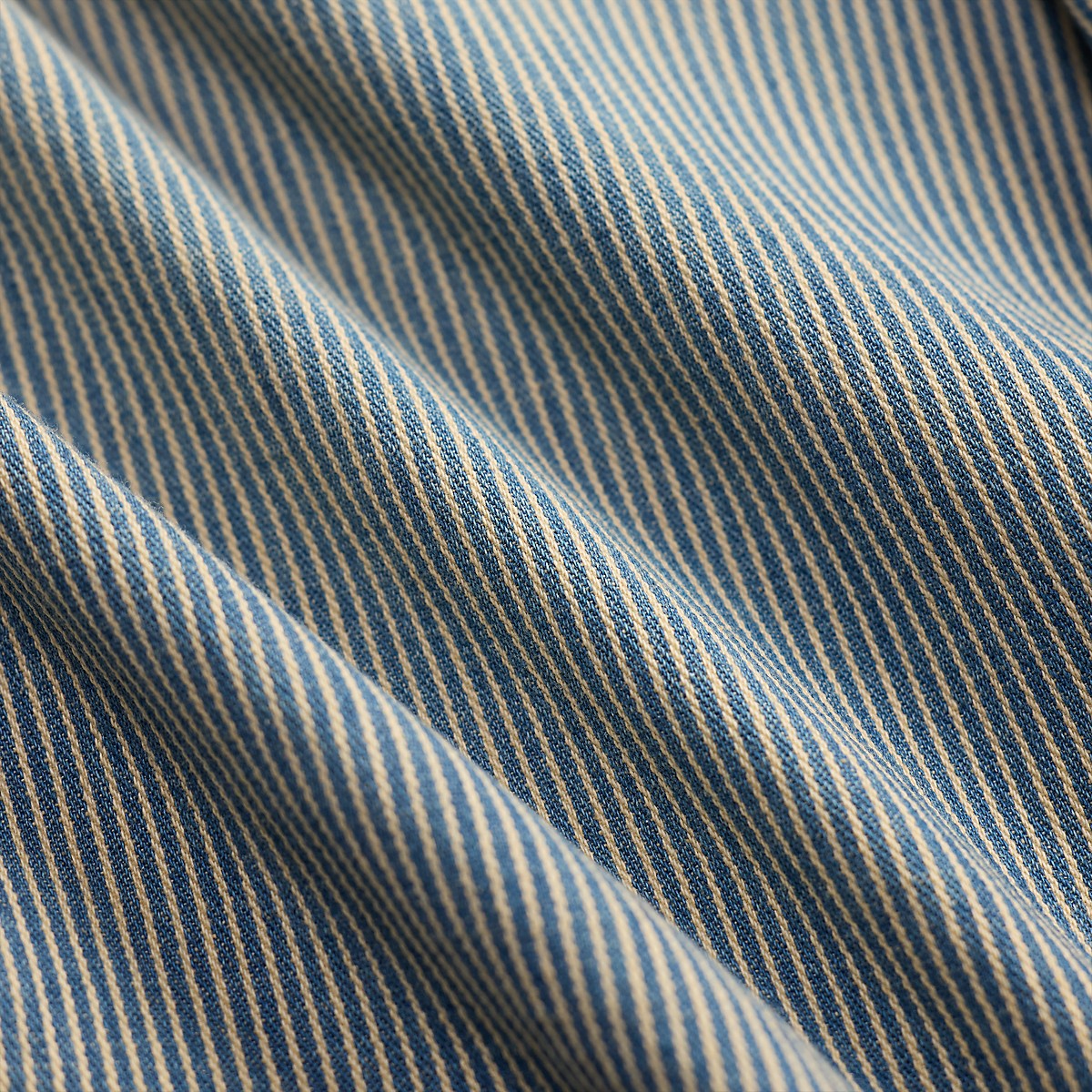 Double RL indigo blue and white striped left-hand twill cotton fabric with a faded, lived-in texture.