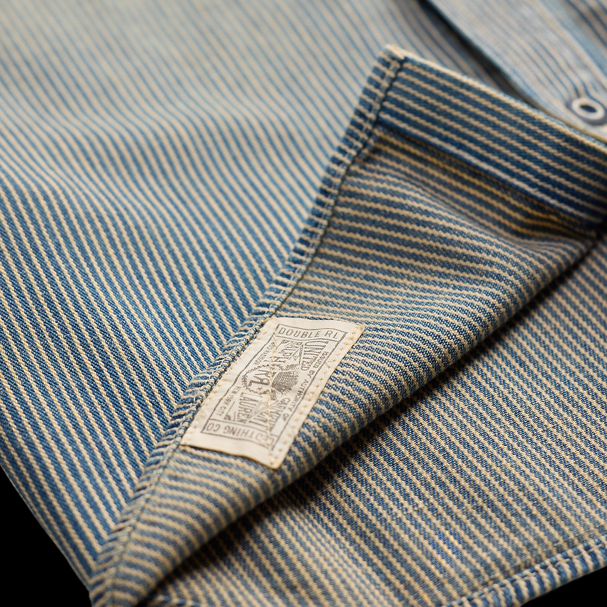 Double RL indigo striped twill workshirt featuring a vintage-inspired label and faded yarn-dyed cotton fabric.
