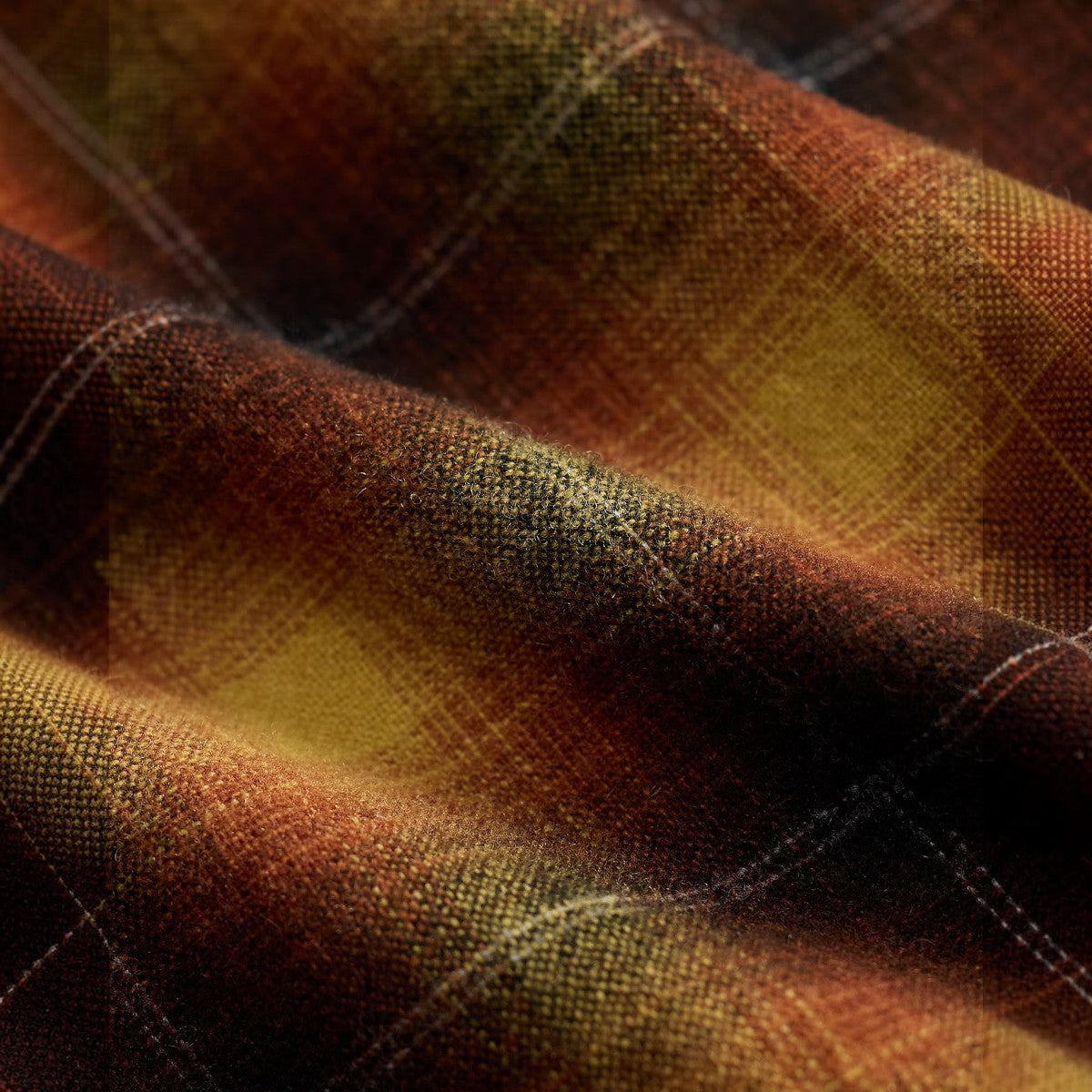 Close-up of RRL orange and yellow plaid wool-blend fabric showing the textured weave and pattern detail.
