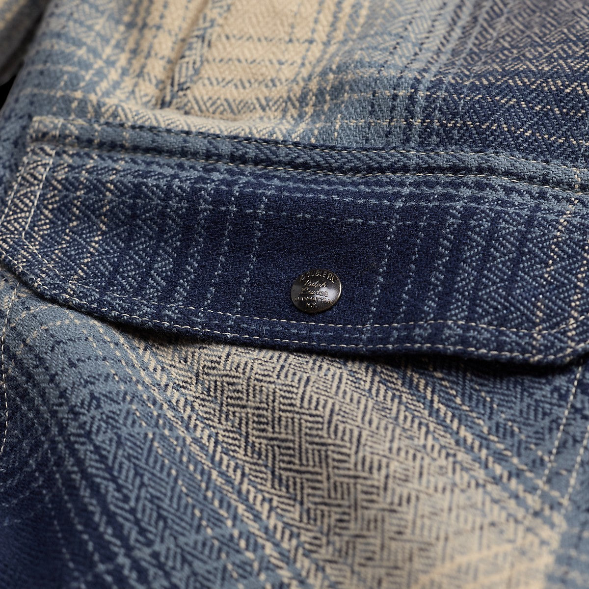 RRL blue and cream plaid wool twill overshirt featuring a detailed chest pocket with a branded metal snap button.