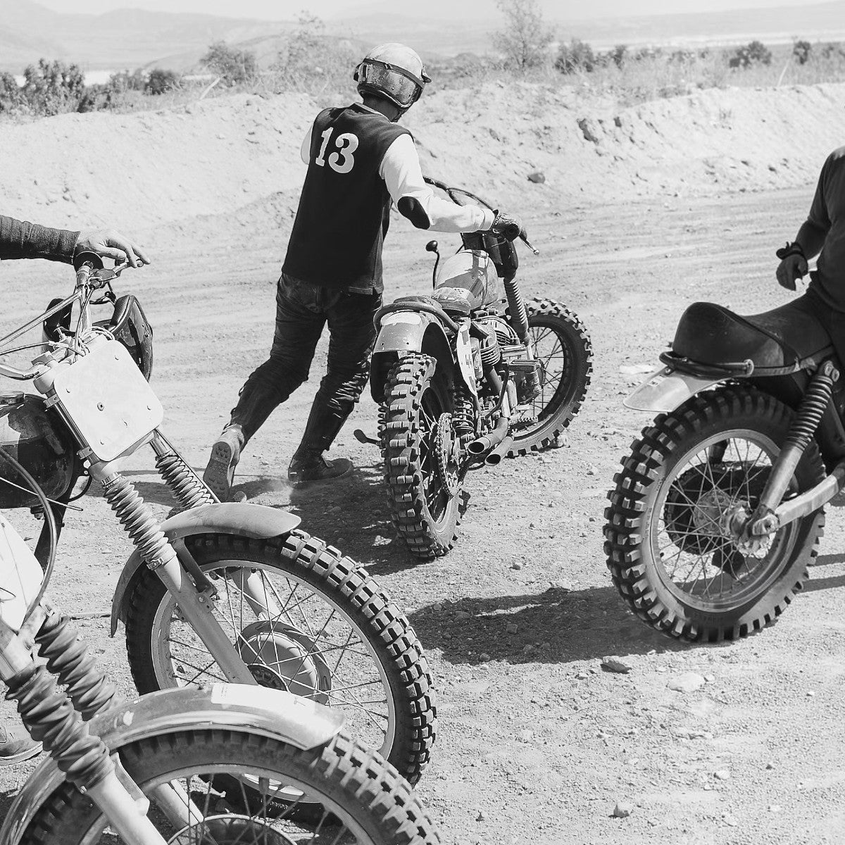 RRL two-tone cotton jersey t-shirt with felt 13 appliqué on back, worn by a motorcyclist on a dirt track