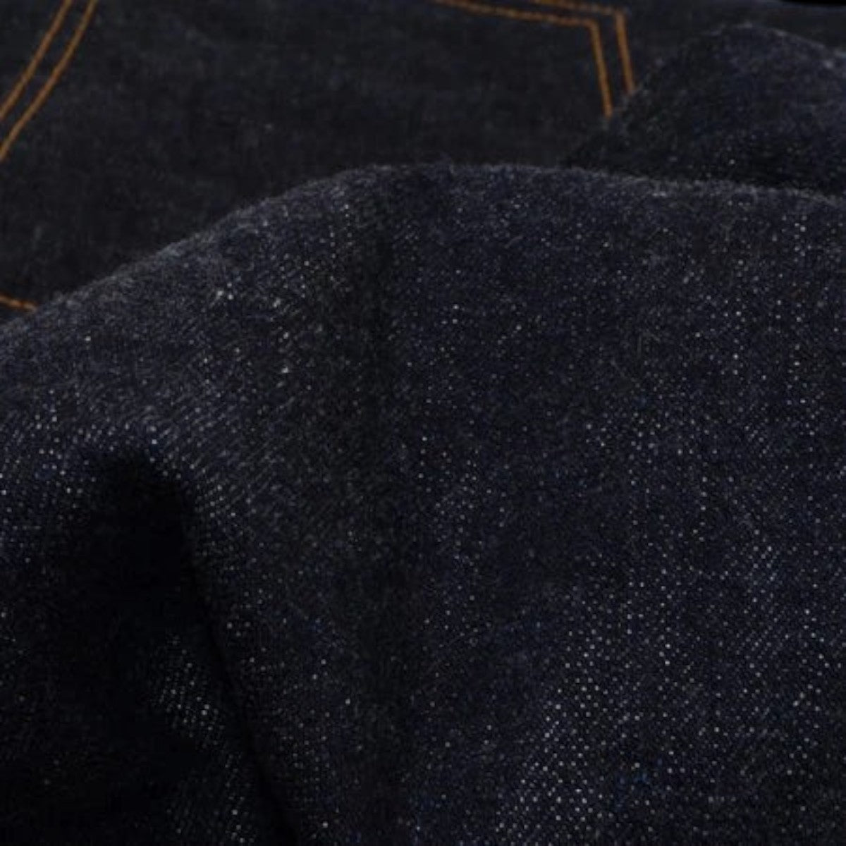 UES 17oz dark indigo selvedge denim fabric with a textured slub cotton weave and contrast stitching