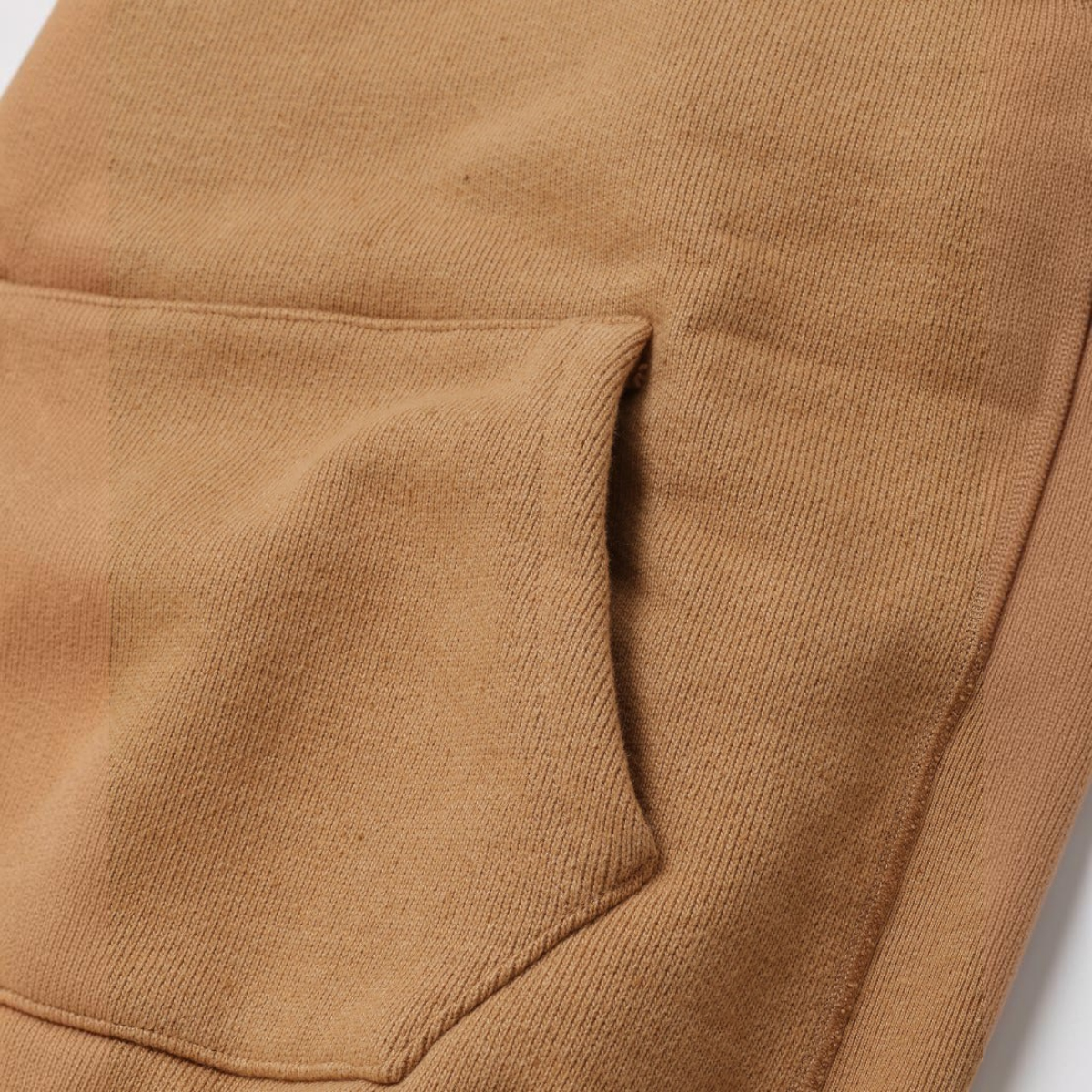 MILWORKS Foxfibre Coyote 80 heavyweight French terry hoodie showing the texture and hand warmer pocket detail.