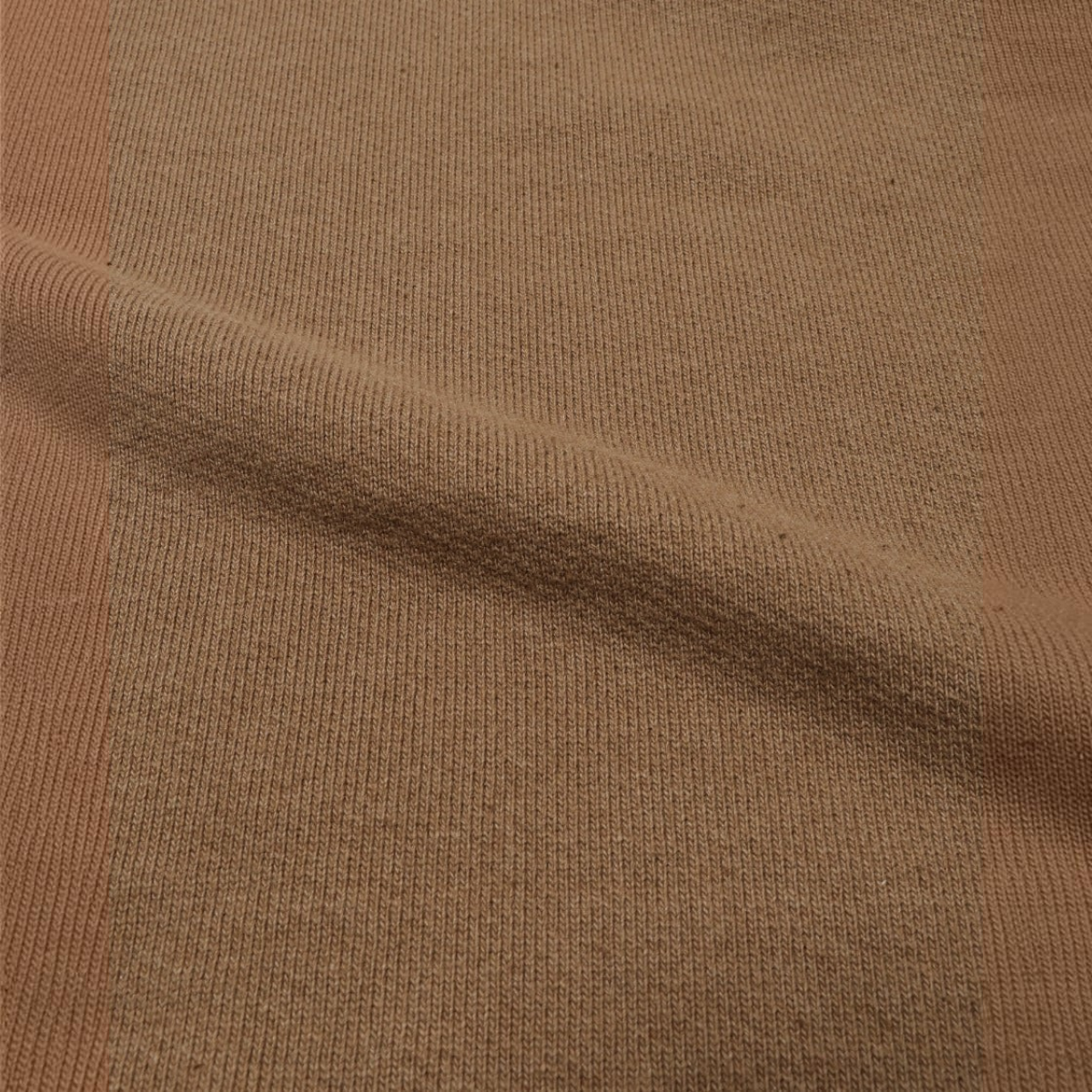 Close-up of milworks.momyote 80 Foxfibre cotton French terry fabric with a rich earthy brown texture.