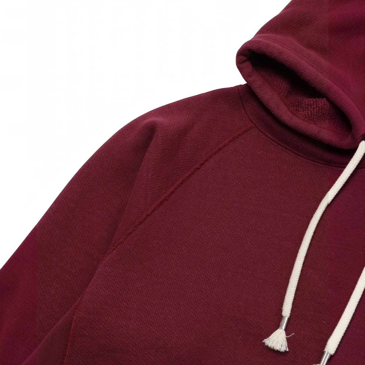 MILWORKS burgundy double heavyweight French terry pullover hoodie with raglan sleeves and cream drawstring hood.