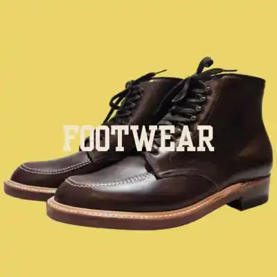 Dark brown leather chukka boots with black laces and a tan rubber sole.