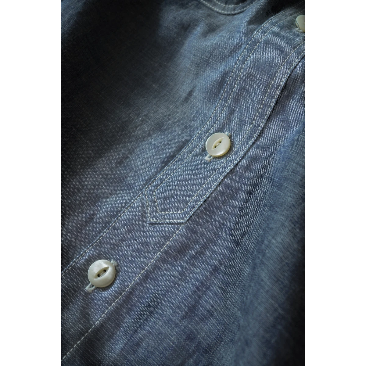 MILWORK blue selvedge chambray work shirt with triple-needle stitching and natural shell buttons.