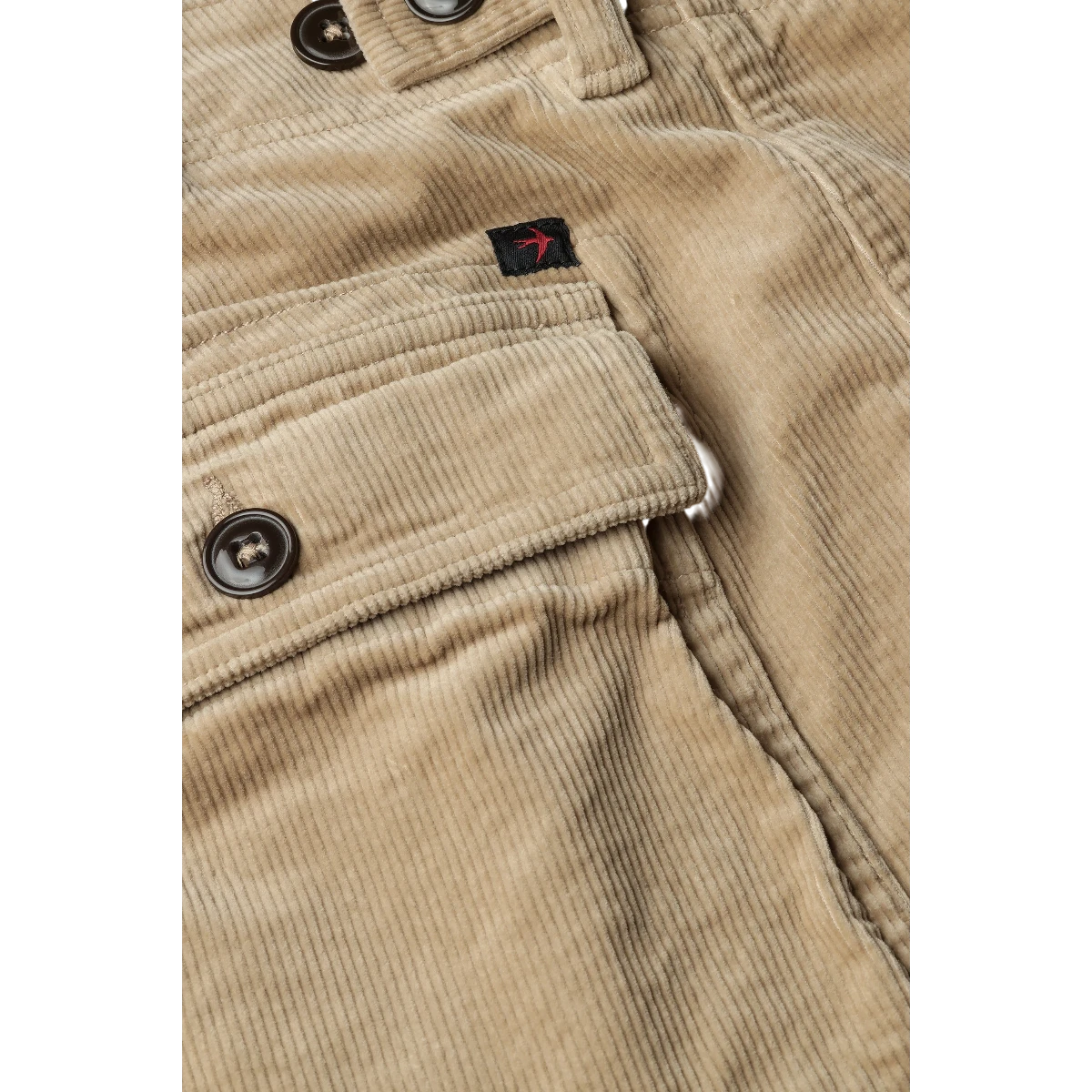 MILWORK Relwen 7.5" buff khaki corduroy shorts with button closure and flap pocket. Features a small red bird logo.
