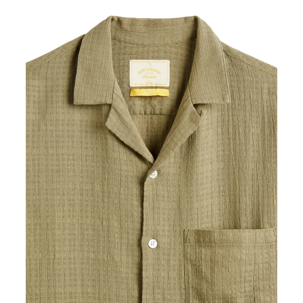 MILWORK Grain Shirt in khaki 100% cotton with mother of pearl buttons and a chest pocket. Features a camp collar and textured weave.