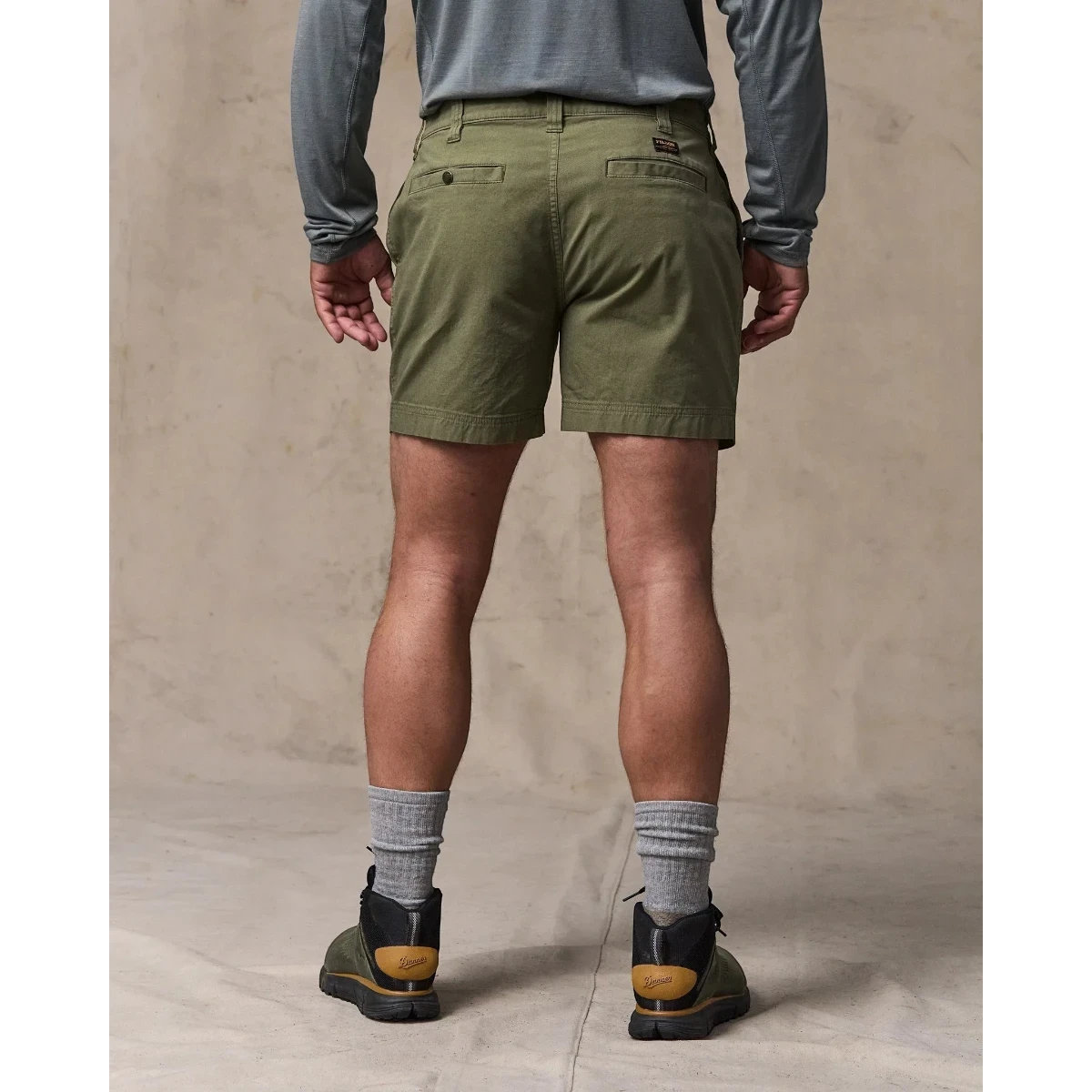 MILWORK Granite Mountain 6" shorts in burnt olive green cotton-blend fabric with welted rear pockets and a snap closure.