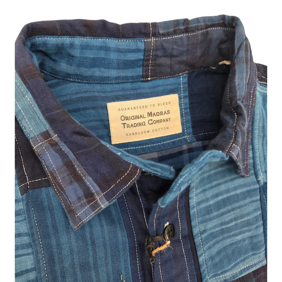 MILWORK indigo blue patchwork cotton utility shirt with button closure and Original Madras Trading Company label.
