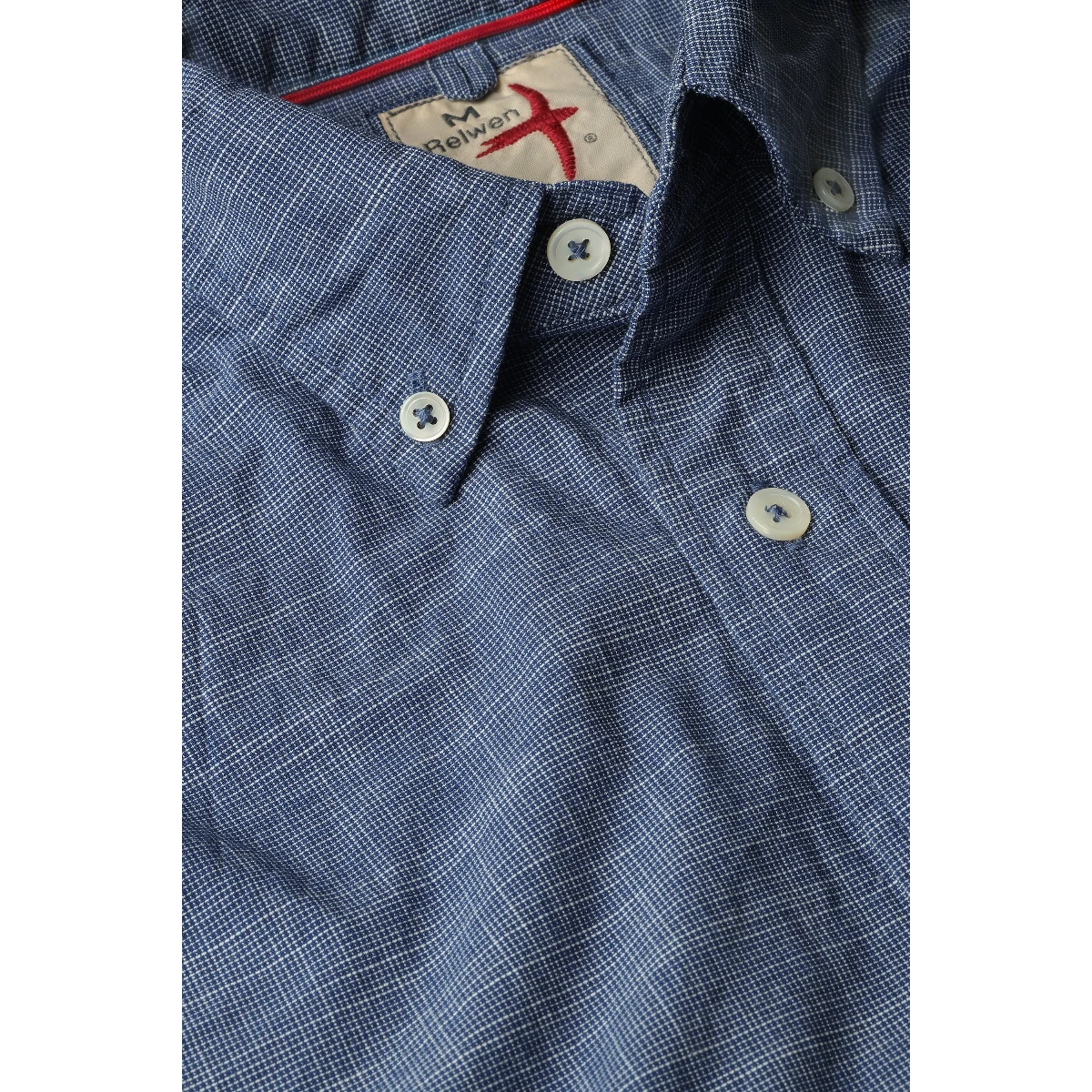 MILWORK navy blue textured button-down shirt with white stitching and white buttons.