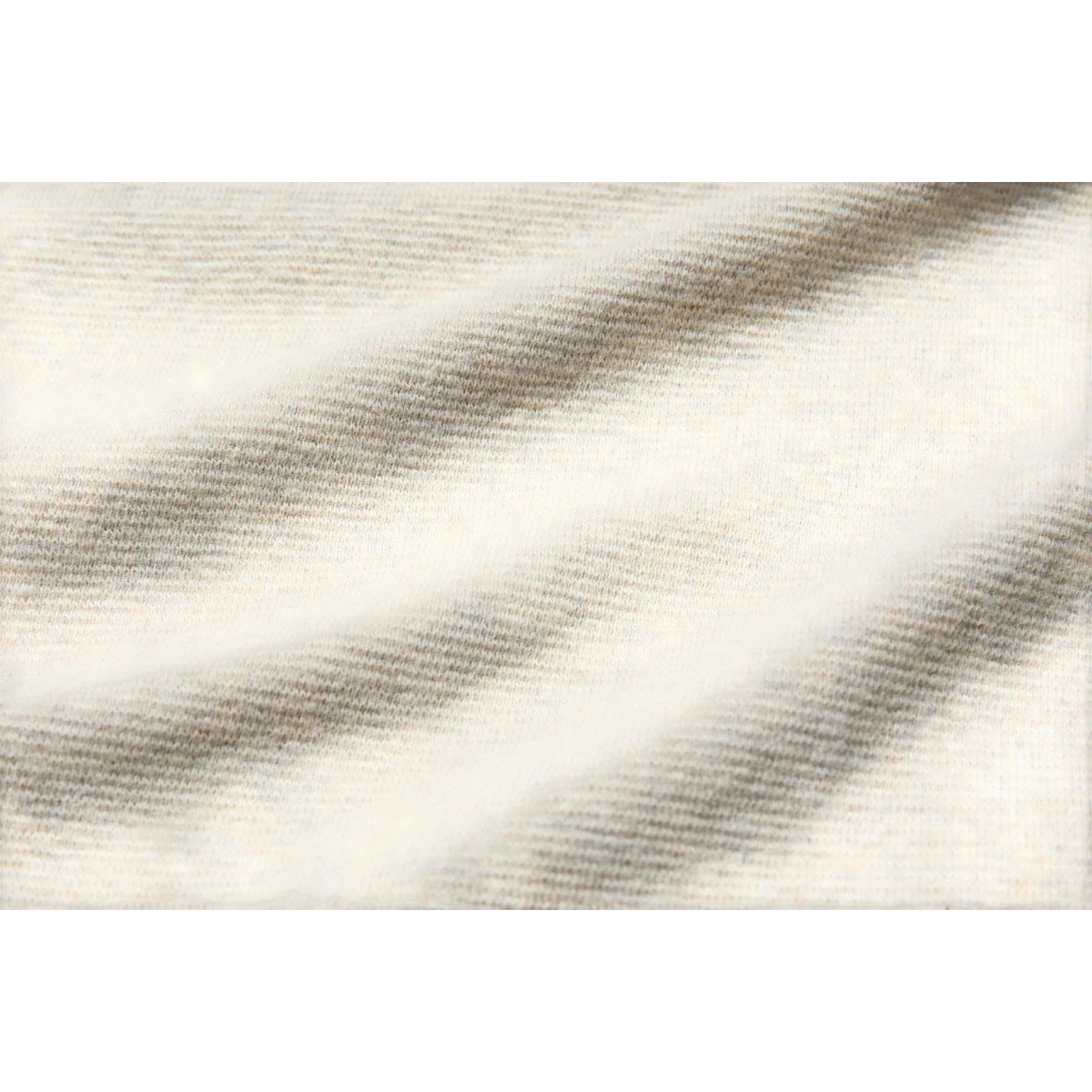 MILWORK Raffy Span Rib Knit Tee in oatmeal, made from a cotton and polyurethane blend with a subtle striped texture.