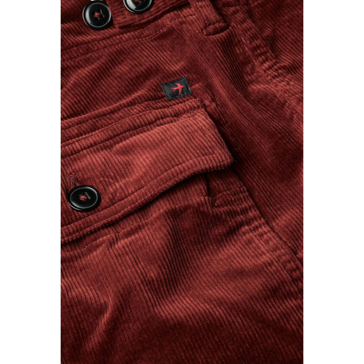 MILWORK Russet corduroy shorts with 7.5" inseam, featuring button closure pockets and a small black logo patch.