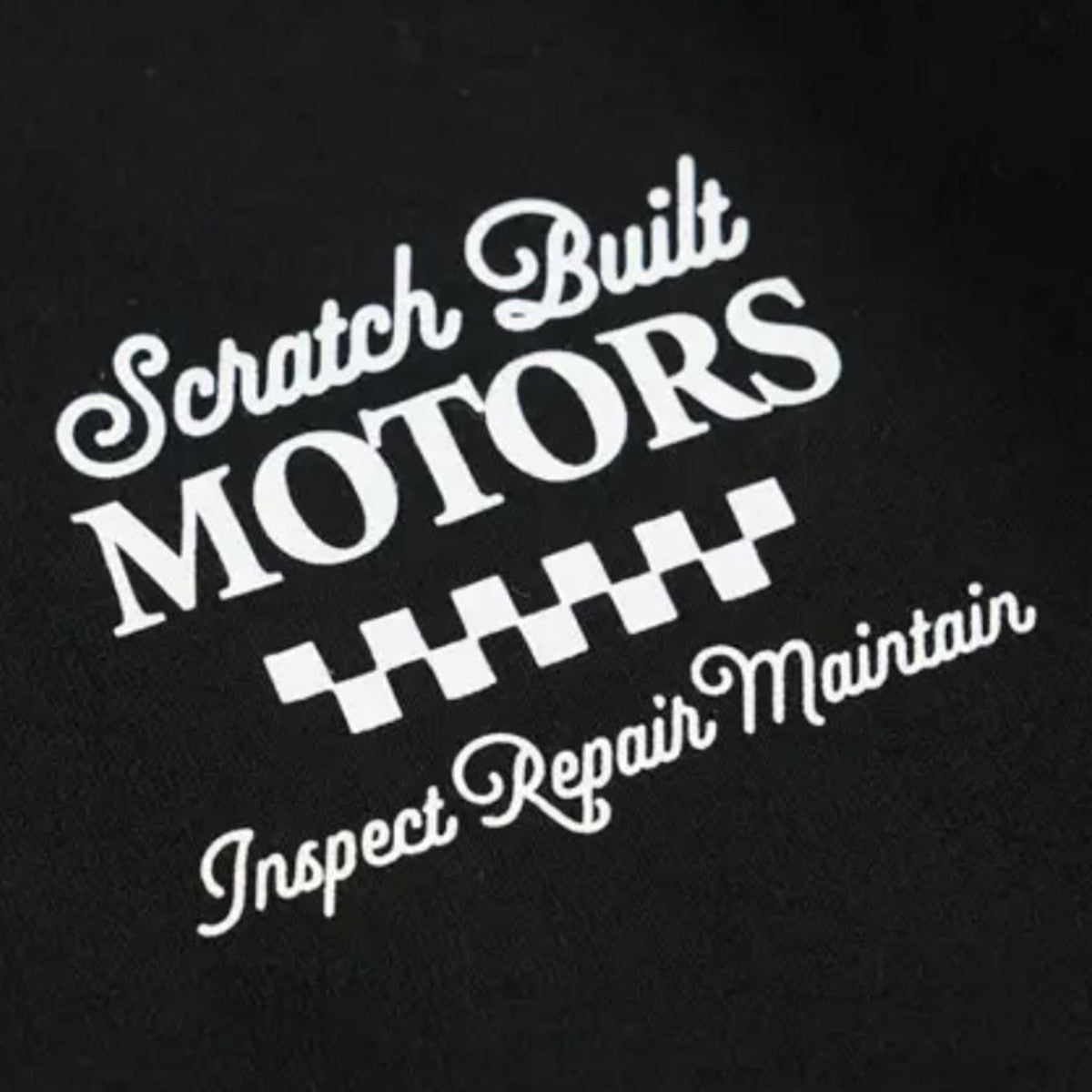 MILWORK Scratch Built Motors black cotton tee with graphic design and checkered flag detail. "Inspect Repair Maintain" text.