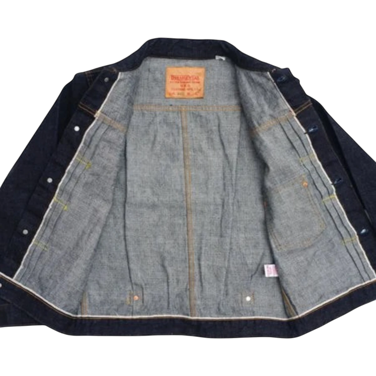 MILWORKS 17oz denim jacket interior view showing raw cotton fabric, leather brand patch, and sturdy construction.