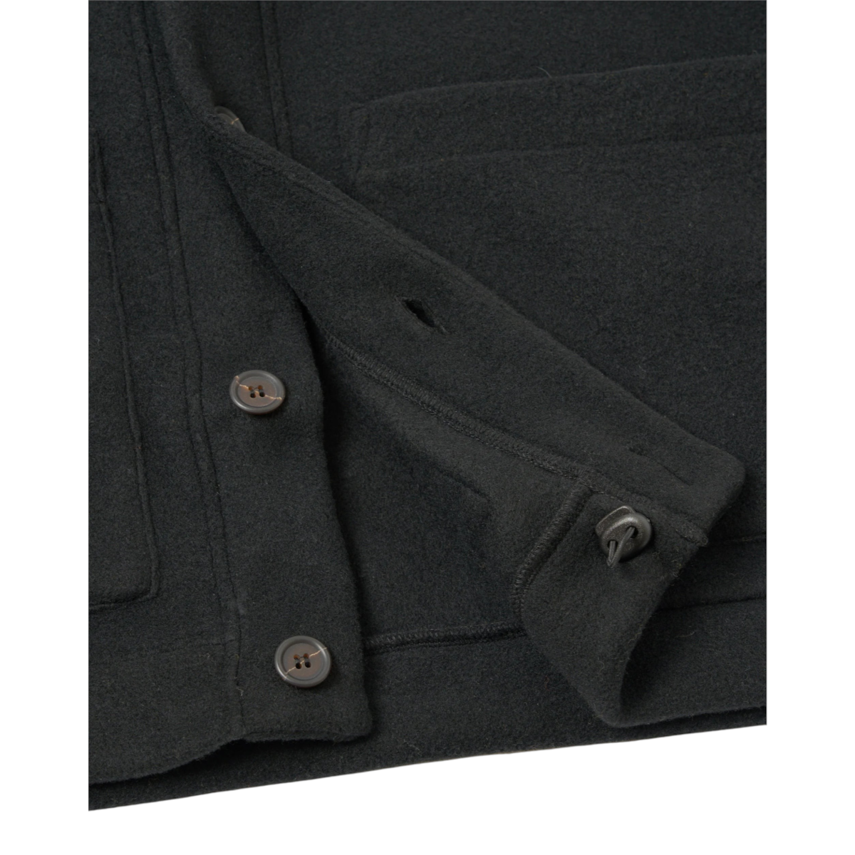 MILWORKS Advance Cardigan in black fleece featuring a button-up front, large patch pockets, and an elasticated hem.