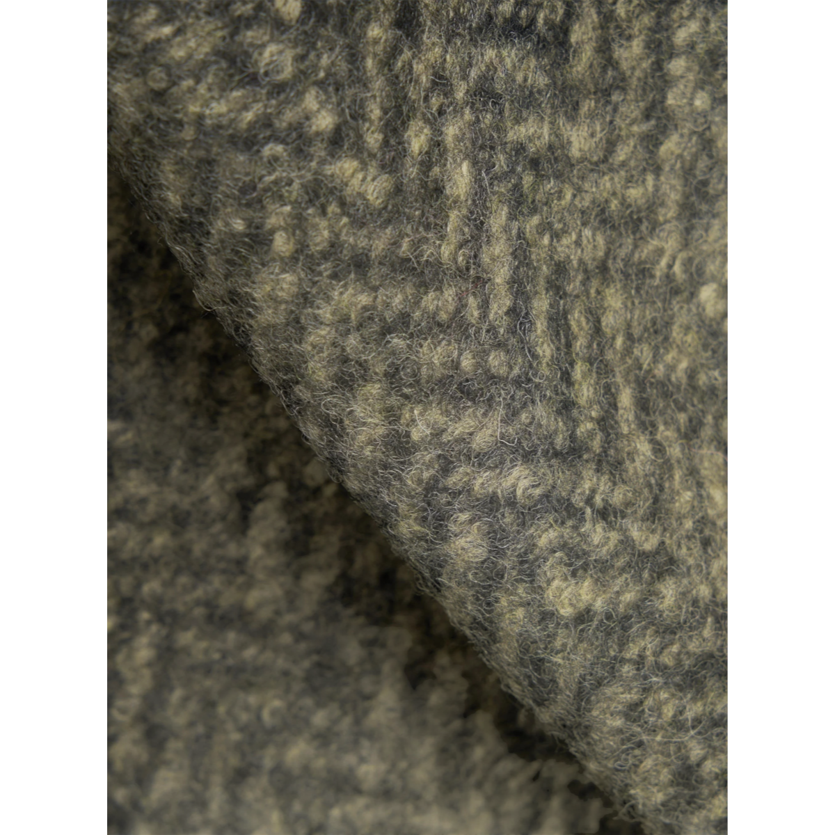 Close-up of the textured olive green Raven fleece fabric used in the MILWORKS Advance cardigan.