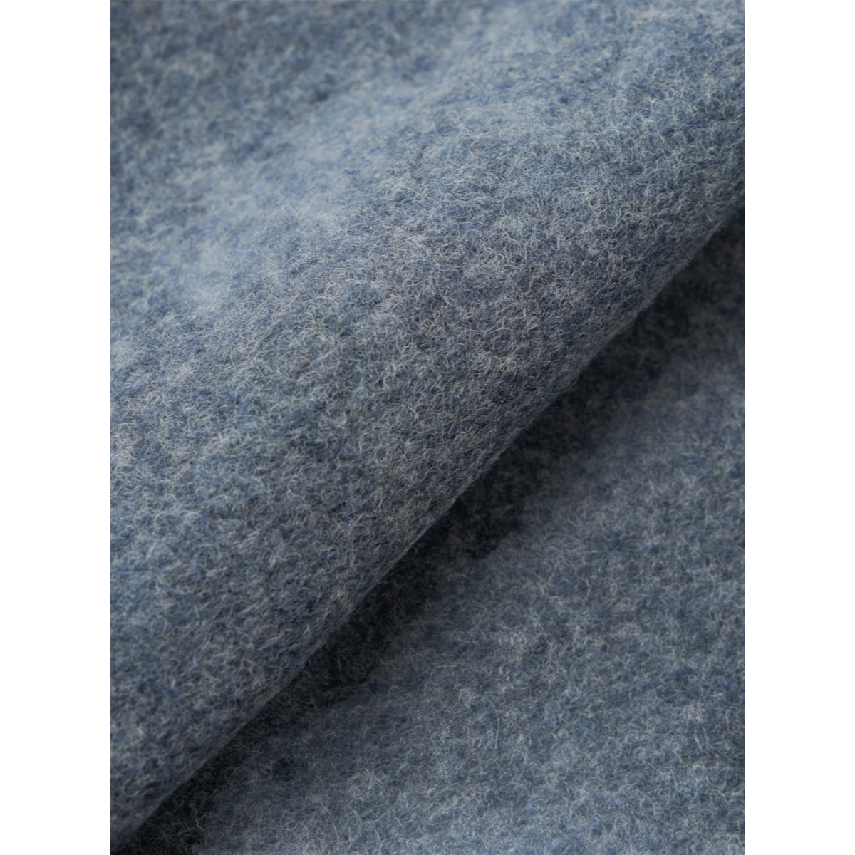 Close-up of MILWORKS Advance cardigan fabric in slate blue wool fleece with a soft, textured finish.
