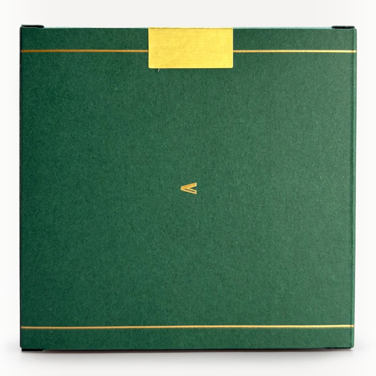 MILWORKS American Ash perfume box in dark green with gold foil accents and a minimalist V logo on the front