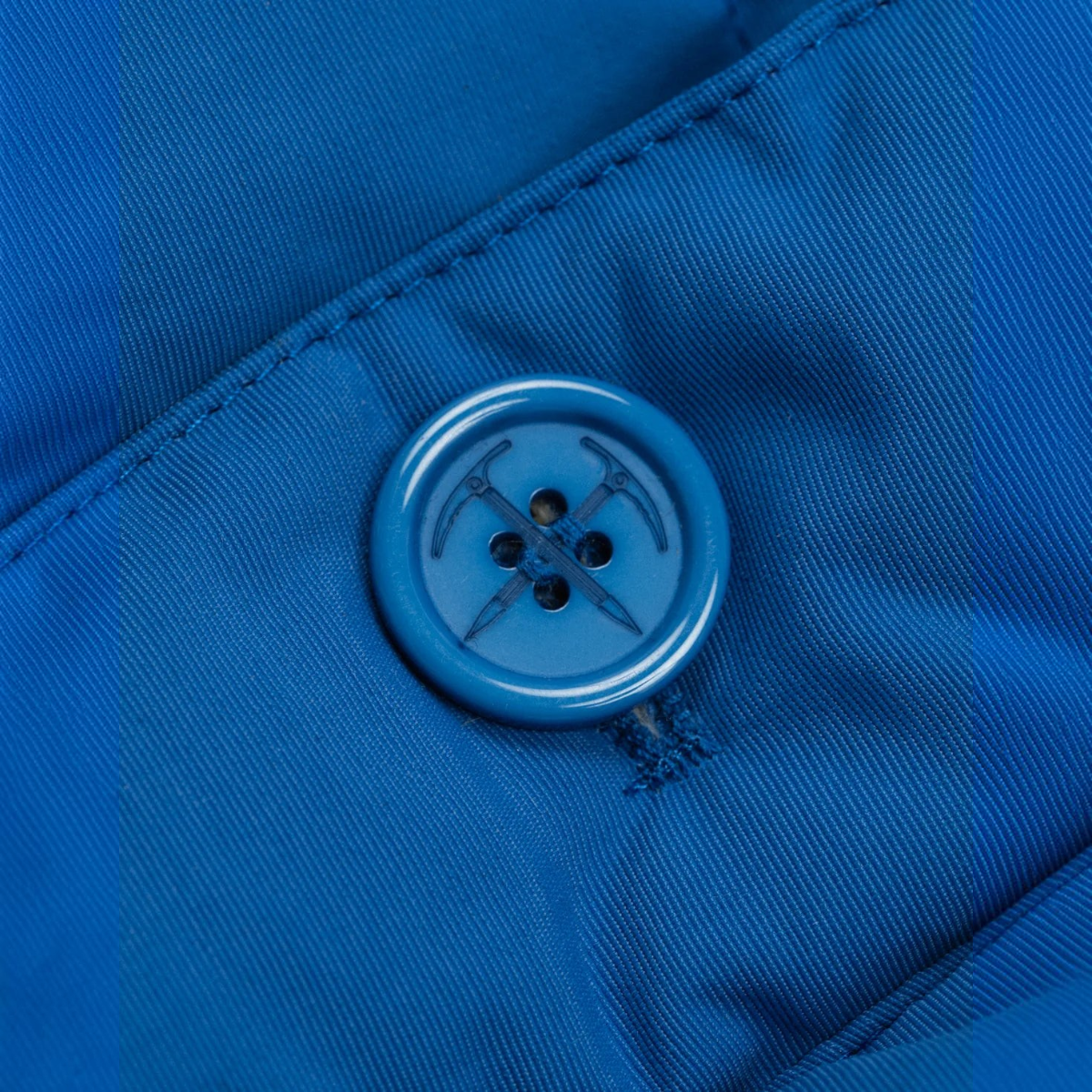 MILWORKS Arctic Parka in blue raspberry featuring a custom ice axe button on a durable nylon shell