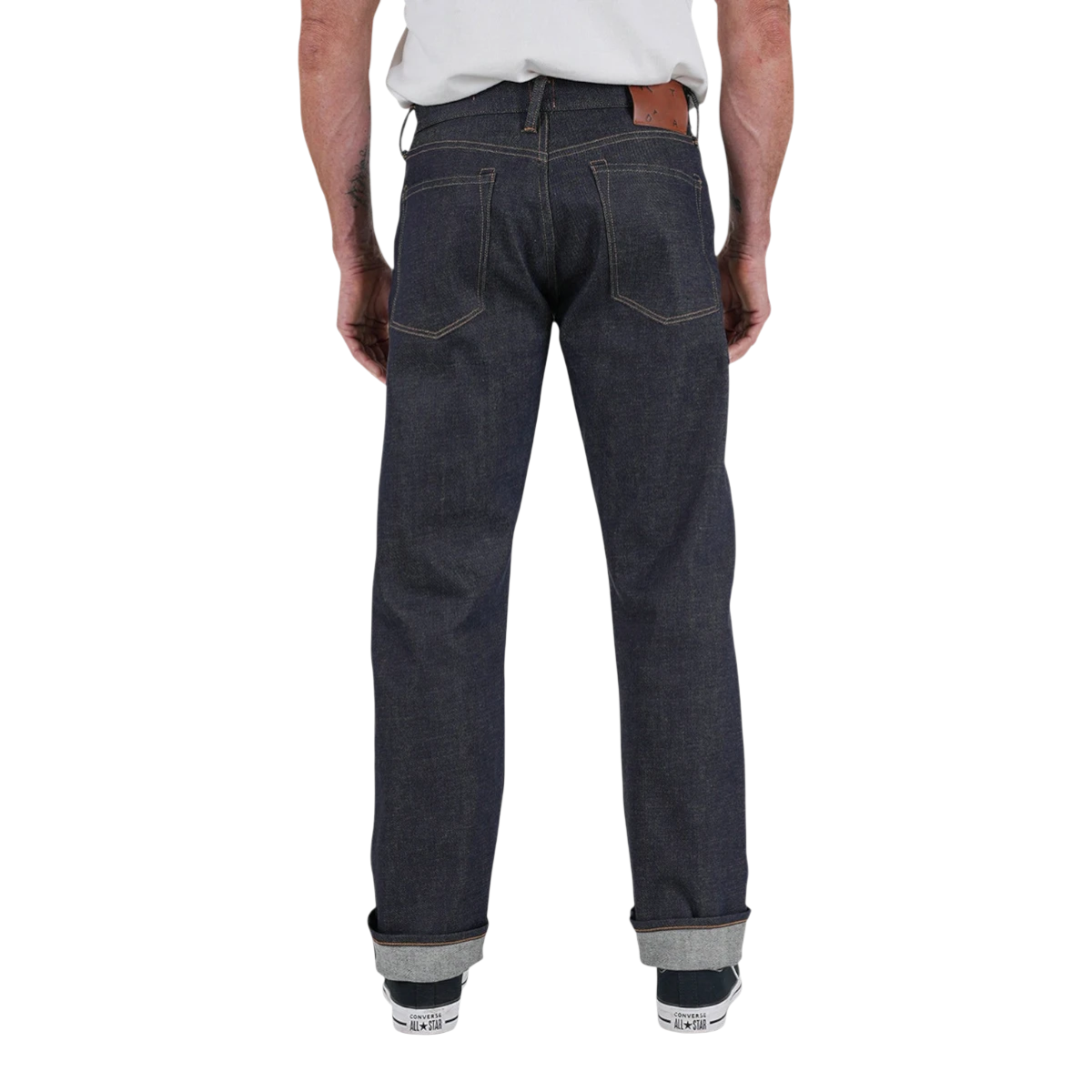 Back view of MILWORKS Barrel Classic straight fit raw indigo Japanese selvedge denim jeans with a leather patch.
