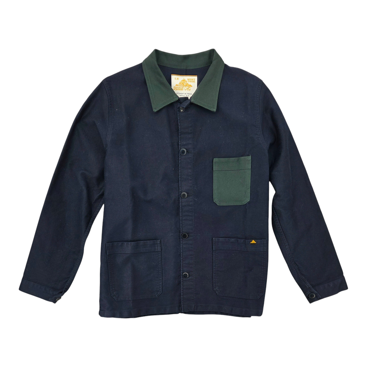 MILWORKS Valoris bicolor work jacket in navy blue cotton with a contrasting forest green collar and chest pocket.