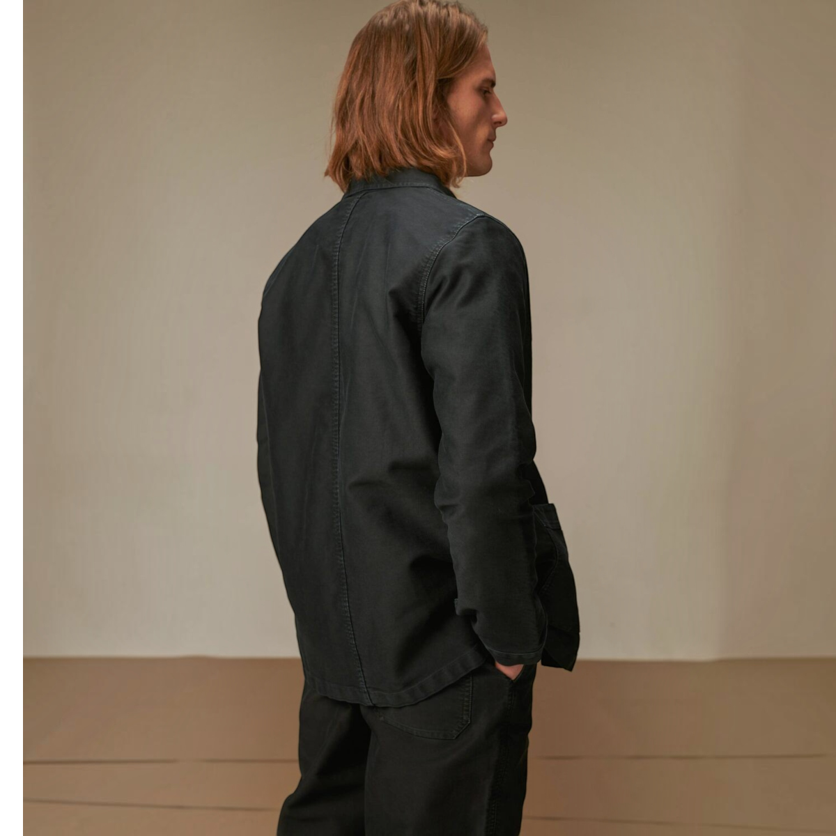 MILWORKS vintage washed black moleskin work jacket worn by a man, back view showing durable cotton construction