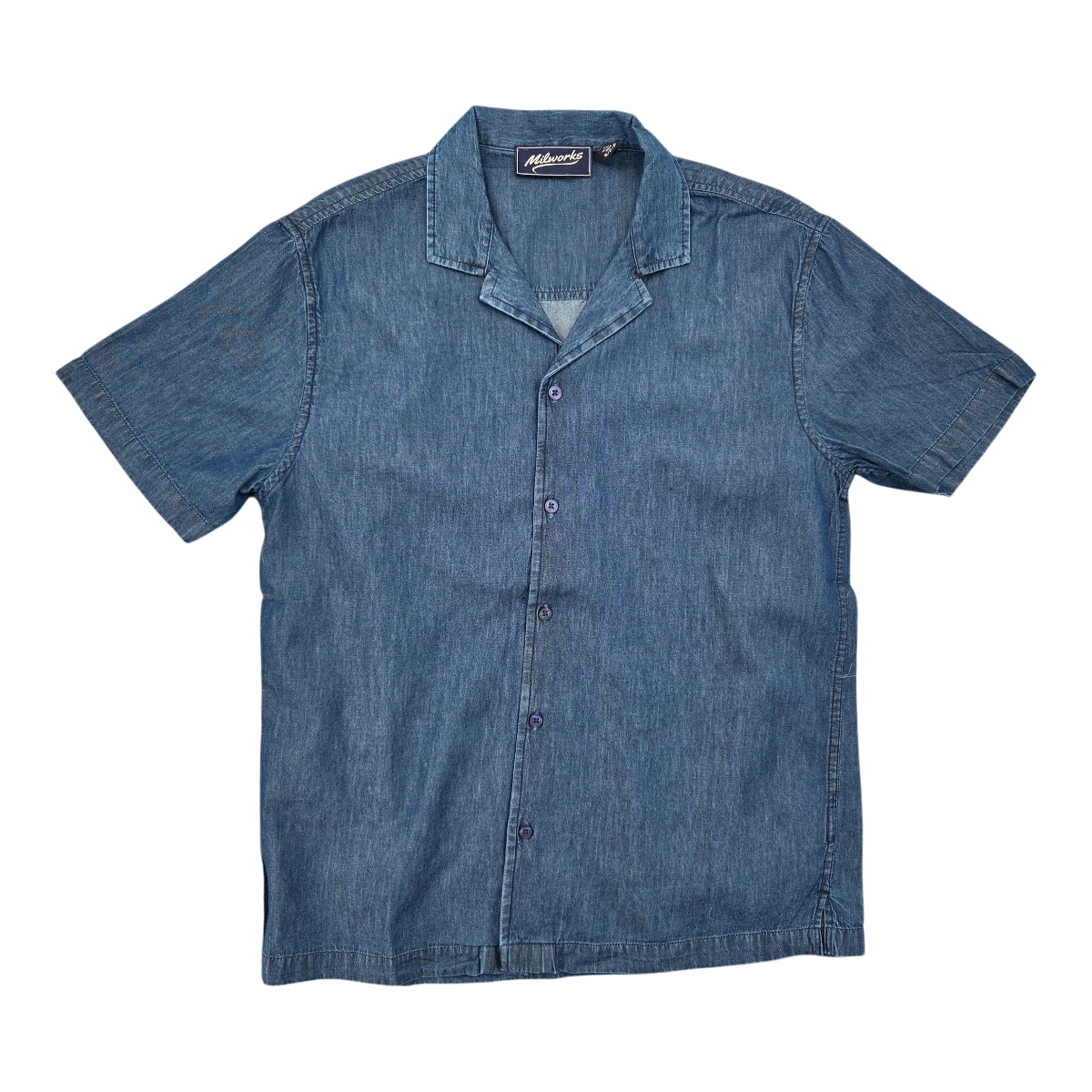 MILWORKS blue denim short-sleeve camp shirt with a spread collar and purple buttons. Crafted from breathable cotton for a lightweight feel.