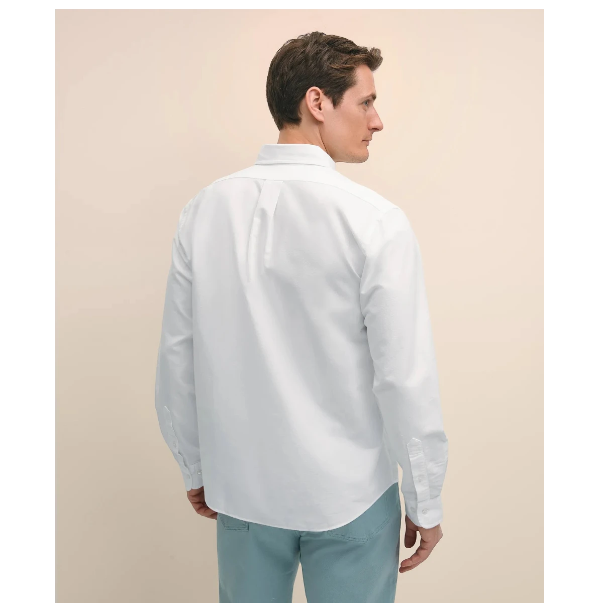 MILWORKS Brooks Brothers white oxford Friday Shirt worn by a man, back view showing button-down collar and cuffs.