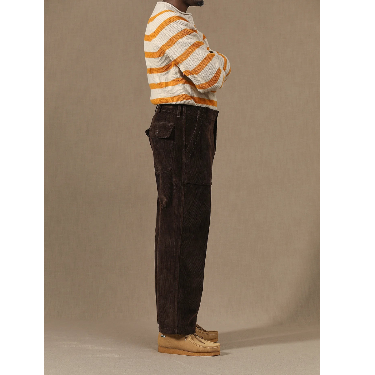 MILWORKS brown corduroy fatigue pants with a relaxed fit and side pockets worn with a striped sweater