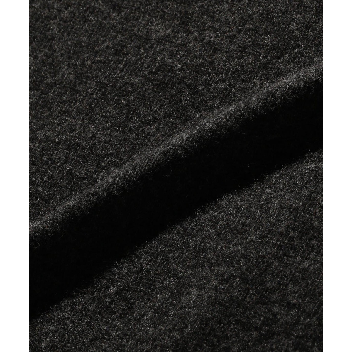 Close-up of the soft charcoal 9-gauge wool knit fabric of a MILWORKS BEAMS PLUS polo shirt