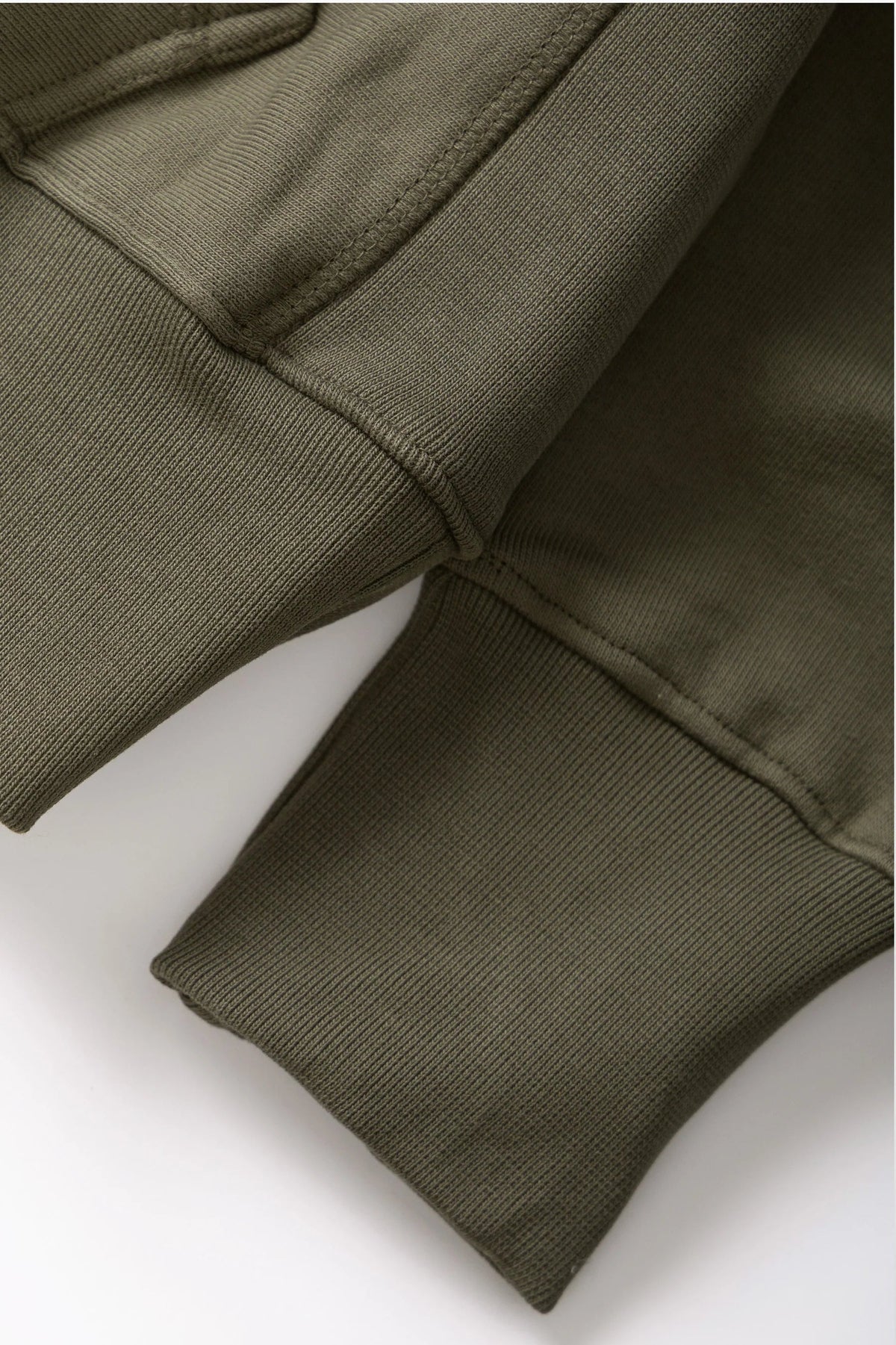 MILWORKS dark olive 16oz organic cotton brushed fleece hoodie showing ribbed cuffs and durable construction