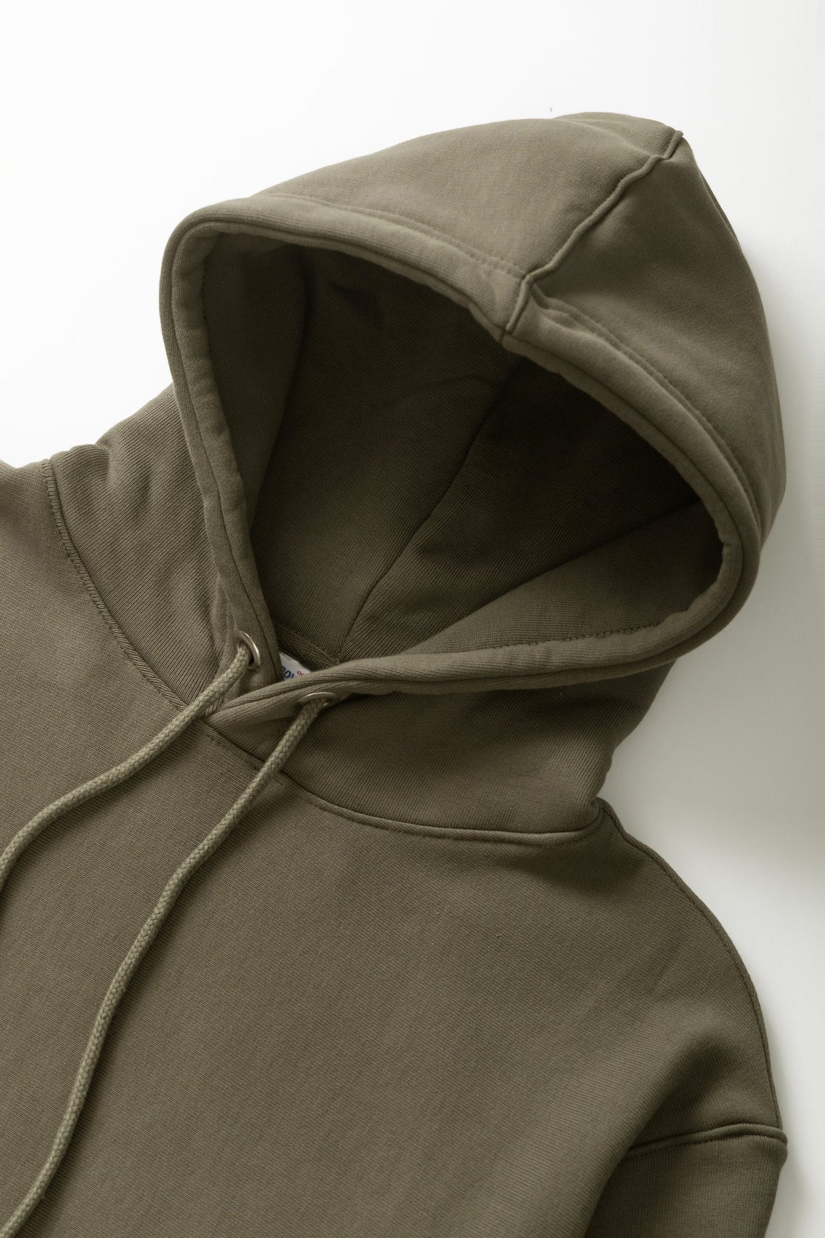 MILWORKS dark olive heavyweight organic cotton hoodie with an adjustable drawstring hood and brushed fleece interior.