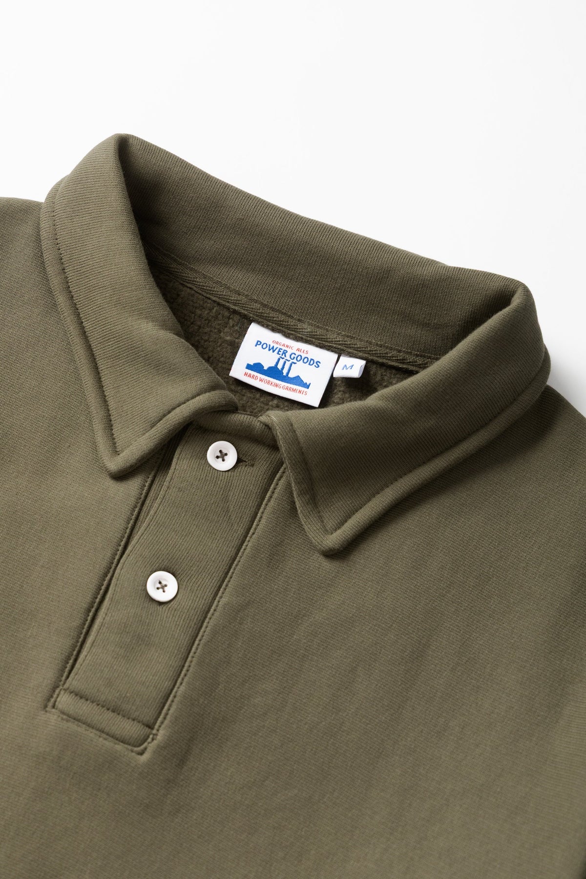 MILWORKS dark olive heavyweight organic cotton rugby shirt with a two-button collar and brushed fleece interior.