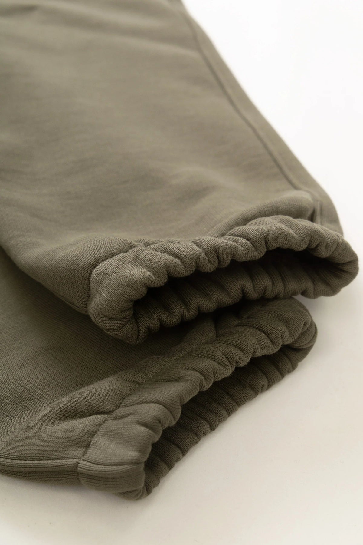 MILWORKS dark olive 16oz organic cotton heavyweight sweatpants featuring elasticated cuffs and brushed fleece texture.