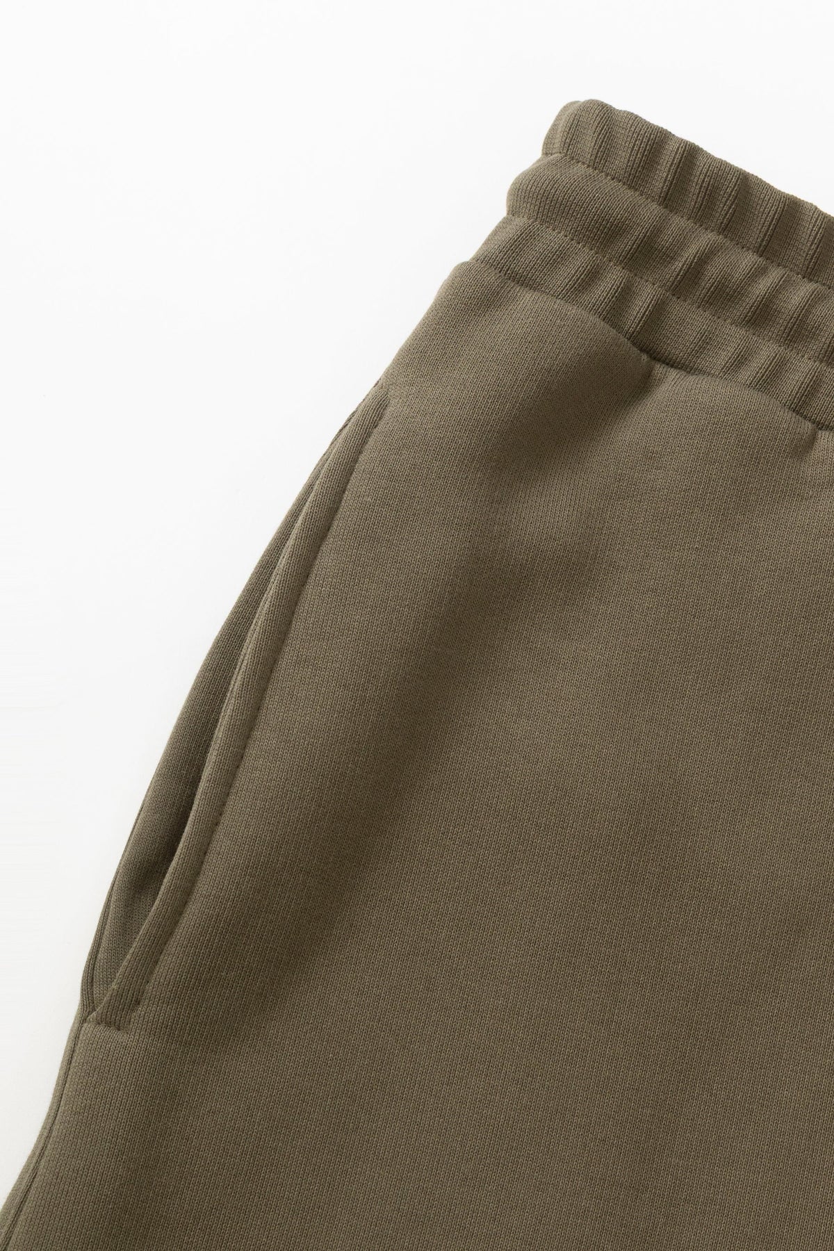 MILWORKS dark olive 16oz organic cotton heavyweight sweatpants featuring an elastic waistband and side pocket detail.
