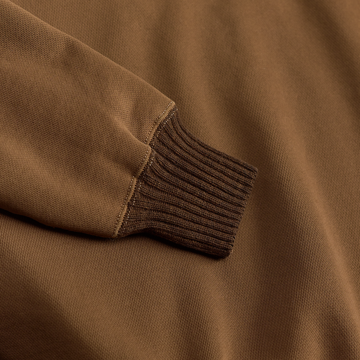 MILWORKS Double RL tan shawl knit fleece sweatshirt showing a close-up of the ribbed cuff and soft fabric texture.