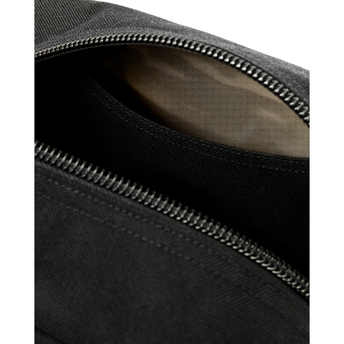MILWORKS Dryden Backpack in black Cordura nylon showing the interior compartment and heavy-duty coil zipper detail.