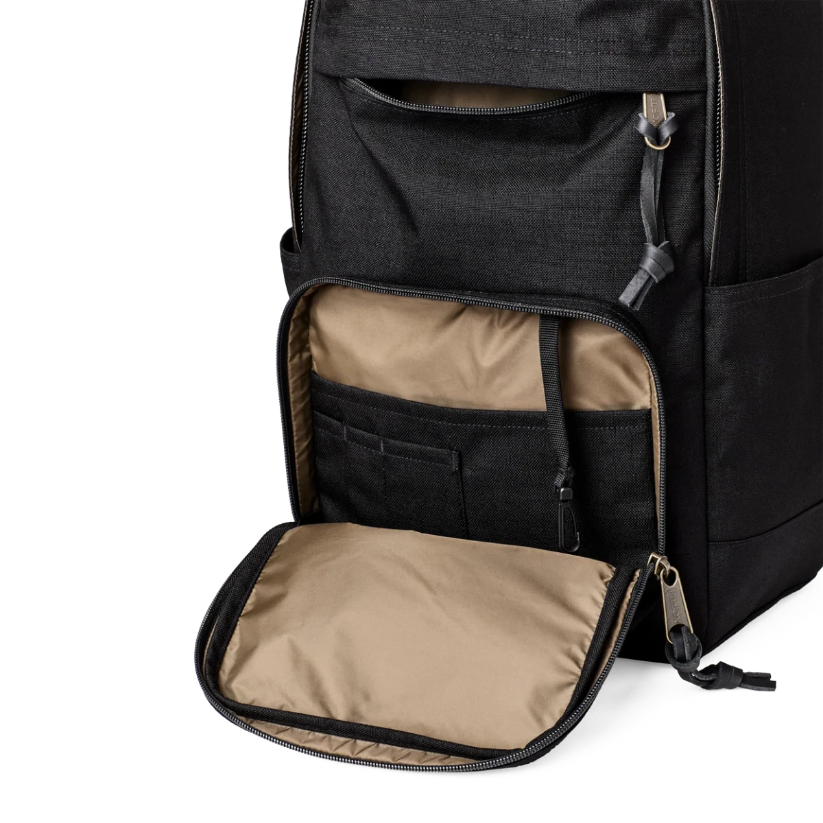 MILWORKS Dryden black Cordura nylon backpack showing open front pocket with internal organization and leather zipper pulls