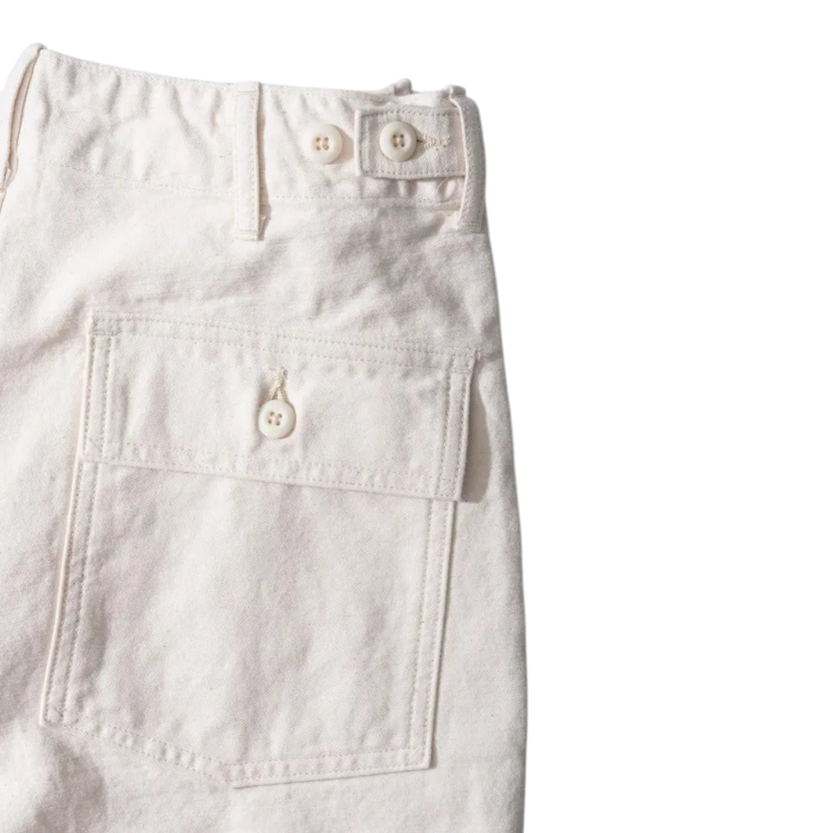MILWORKS vintage fatigue pants in ecru back sateen fabric featuring a buttoned back pocket and adjustable waist tabs.