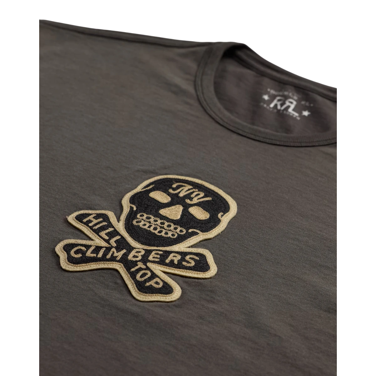 MILWORKS faded black cotton jersey t-shirt featuring a vintage motorcycle skull patch with chain-stitched embroidery.