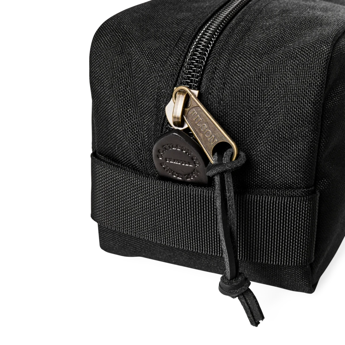 MILWORKS Filson Dryden black Cordura nylon travel pack with a sturdy zipper and leather pull tab detail.