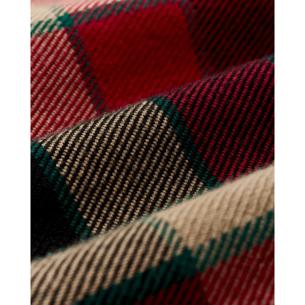 MILWORKS Filson vintage flannel work shirt fabric close-up featuring red, cream, and green plaid brushed cotton twill.