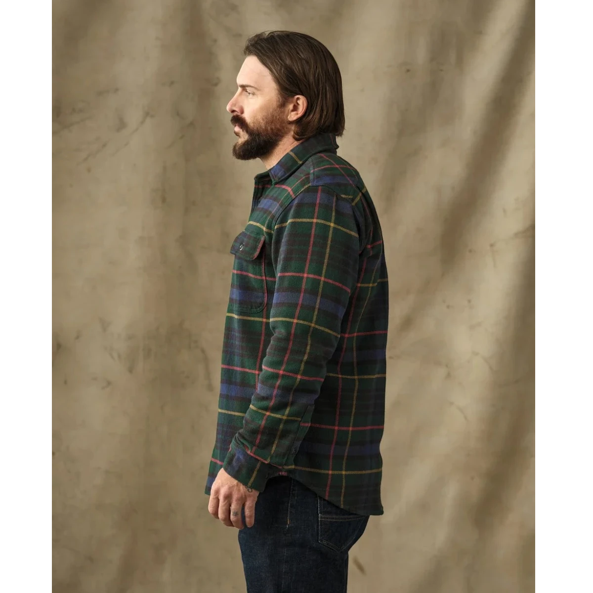 MILWORKS Filson vintage green and navy plaid flannel work shirt worn by a man in profile view
